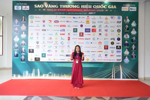 A person standing in front of a large posterDescription automatically generated